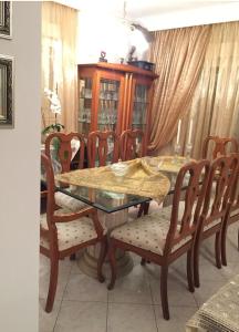 a dining room table and chairs with a glass table and a table and chairs at Respect to the Guest in Thessaloniki