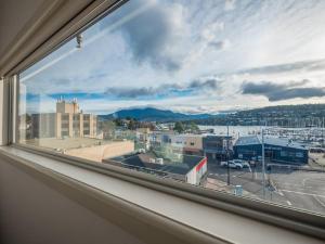a view of a city from a window at Marina View Apartment in Hobart