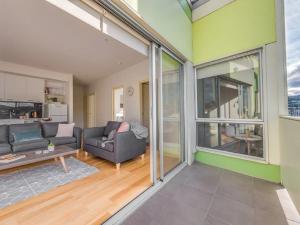 a living room with a couch and a table at Marina View Apartment in Hobart