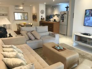 a living room with a couch and a table in it at Flat 3 suites frente mar in Florianópolis