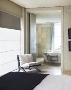 a bathroom with a chair and a bath tub at Establishment Hotel in Sydney