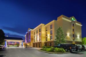 a hotel with cars parked in a parking lot at Holiday Inn Express Hotel & Suites Fort Wayne, an IHG Hotel in Fort Wayne