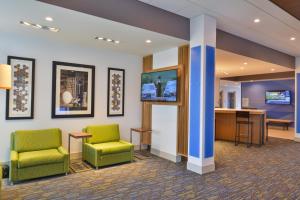 a waiting room with two chairs and a desk at Holiday Inn Express & Suites Omaha Airport, an IHG Hotel in Carter Lake