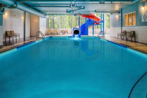 a swimming pool with a slide in a building at Holiday Inn Express & Suites Halifax - Bedford, an IHG Hotel in Halifax