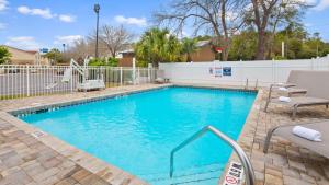 a swimming pool with a slide in a yard at Best Western Niceville - Eglin AFB Hotel in Niceville