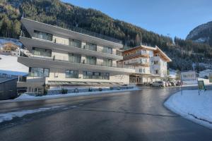 a large building in the middle of a street at Wolfs Aparts + More in Ischgl