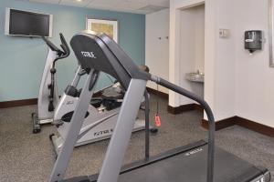 a gym with a treadmill and a flat screen tv at Holiday Inn Express Fresno River Park Highway 41, an IHG Hotel in Fresno