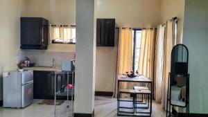 a small kitchen with a refrigerator and a small table at Carlo'S Place in Dumaguete
