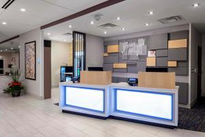 a lobby with a counter with boxes on it at Holiday Inn Express & Suites - Madison by IHG in Madison +30 photos