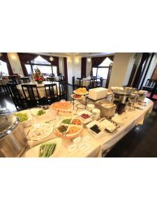 a buffet table with many plates of food on it at Chofu Urban Hotel in Chofu