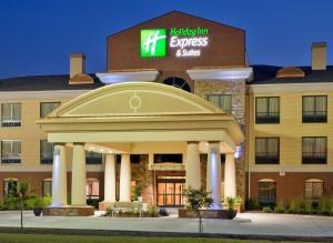 a hotel with a sign on the front of a building at Holiday Inn Express Hotel & Suites Greenville by IHG in Greenville
