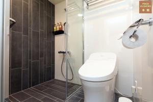 a bathroom with a toilet and a glass shower at Hotel Global View Kushiro in Kushiro