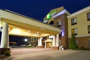 a hotel with a sign on the front of a building at Holiday Inn Express Hotel & Suites Goshen, an IHG Hotel in Goshen