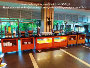 a counter with food on it in a room at Hotel Gren Alia Jakarta in Jakarta