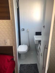 La petite salle de bains est pourvue de toilettes et d'un lavabo. dans l'établissement apartamento próximo a praia da Enseada, à Guarujá