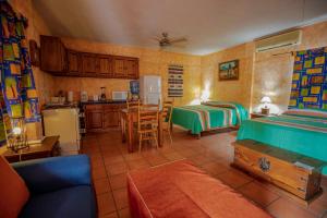 a living room with two beds and a kitchen at Hotel Posada Luna Sol in La Paz