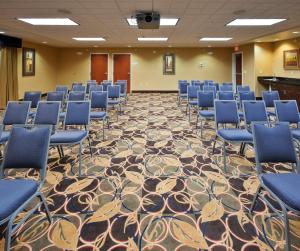 a conference room with blue chairs and a carpet at Holiday Inn Express and Suites Great Falls by IHG in Great Falls