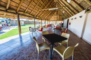 a patio with tables and chairs in a restaurant at Ritsako Game Lodge in Klipdrift