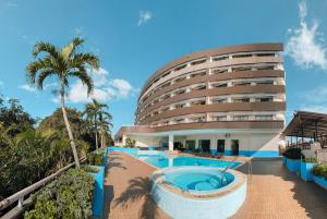 a hotel with a swimming pool and a building at Loei Palace Hotel in Loei