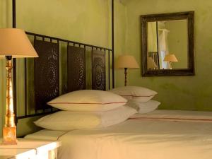 a bedroom with a bed with pillows and a mirror at Sea View Villa Dvori Sv. Jurja in Jelsa