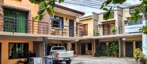a truck parked in front of a building at Carlo'S Place in Dumaguete