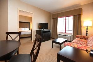 a hotel room with a couch and a bed at Holiday Inn Express & Suites - Olathe North by IHG in Olathe