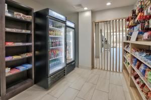 a grocery store aisle with a soda refrigerator at Holiday Inn Express & Suites - Houston East - Beltway 8, an IHG Hotel in Cloverleaf