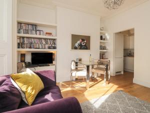 a living room with a purple couch and a table at Mount Sion in Royal Tunbridge Wells