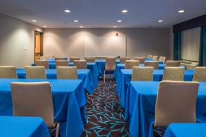 a conference room with blue tables and chairs and a whiteboard at Holiday Inn Express Hotel & Suites Livermore, an IHG Hotel in Livermore