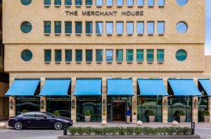 a building with a car parked in front of it at The Merchant House in Manama