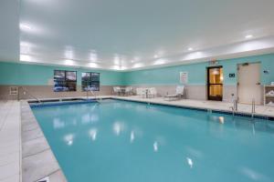 a swimming pool in a large room with blue walls at Holiday Inn Express Hotel & Suites Canton, an IHG Hotel in Canton