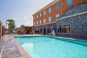 une piscine en face d'un bâtiment dans l'établissement Holiday Inn Express Hotel & Suites Clute-Lake Jackson, an IHG Hotel, à Clute