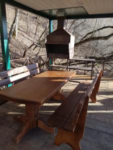 a wooden picnic table and bench on a deck at Inn Ivan Da Marya in Dakhovskaya