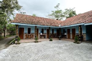 een huis met blauwe muren en een binnenplaats bij Willy Homestay Borobudur in Borobudur