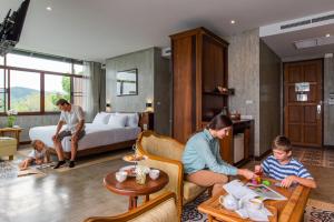 a group of people sitting in a living room at Bansaeo Garden and Resort in Chiang Saen