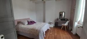 a bedroom with a bed and a dresser and a mirror at Les Eygletières in Bourriot-Bergonce