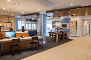 an office lobby with a bar with chairs and a kitchen at Holiday Inn Express & Suites - Marietta, an IHG Hotel in Marietta