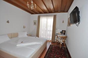 Postel nebo postele na pokoji v ubytování Hotel Stülzis