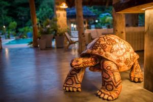 a statue of an elephant in the middle of a walkway at Les Lauriers Eco Hotel in Anse Volbert Village