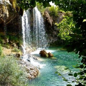 a waterfall on the side of a river at Royuela Hostal in Royuela