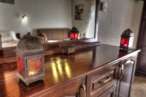 a living room with a wooden counter top with lights on it at Toula Rooms in Angistron