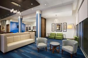 a lobby of a hospital with a couch and chairs at Holiday Inn Express & Suites - McAllen - Medical Center Area, an IHG Hotel in McAllen