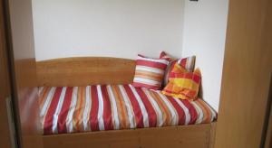 a bed with two pillows sitting on top of it at Sägerhof Bader in Rettenberg