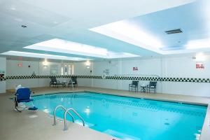 a large swimming pool with blue water at Holiday Inn & Suites Raleigh Cary, an IHG Hotel in Cary