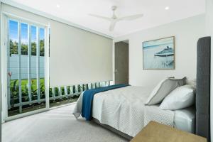 a bedroom with a bed and a large window at Magnificent views on Arkana, Noosa Heads in Noosa Heads +36 photos
