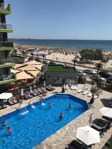 - un groupe de personnes dans une piscine à côté d'une plage dans l'établissement Apartament Adrian-Beach Resort, à Mamaia Nord – Năvodari