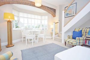 a living room with a table and chairs at Seagull Cottage, Aldwick in Bognor Regis