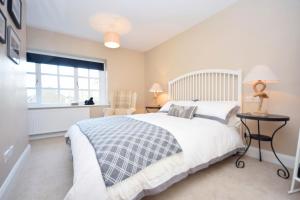 a bedroom with a large bed and a window at Seagull Cottage, Aldwick in Bognor Regis
