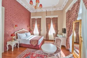 a bedroom with a bed and a table and chairs at Enderun Hotel Istanbul in Istanbul