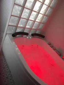 a red bath tub in a room with a window at Casa Rural Aguachales in Villanueva-Matamala +22 photos